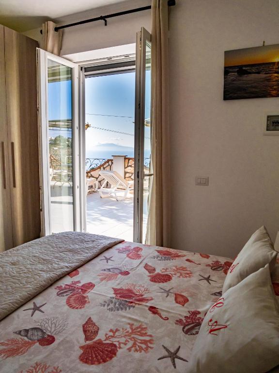 a bedroom with a bed with a view of the ocean at Casa Astra in Anacapri