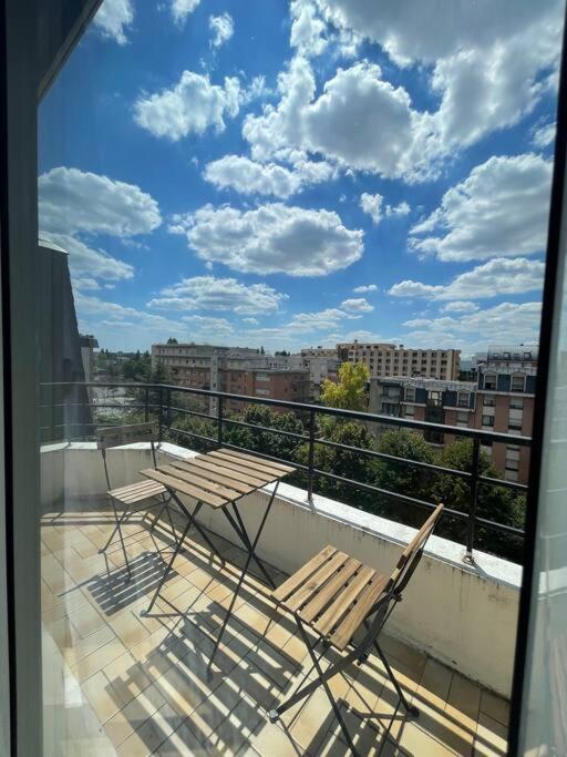 two chairs and a table on a balcony at APPARTEMENT COSY Balcon à 30min de PARIS in Cergy