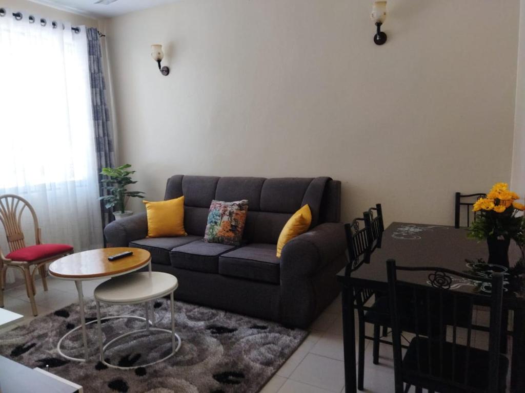 a living room with a couch and a table at Ocean Home, Nyali Mombasa in Mombasa