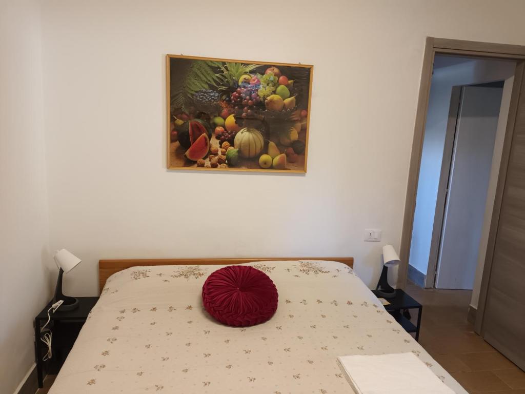 a bed in a room with a painting on the wall at levante rooms in Scalea