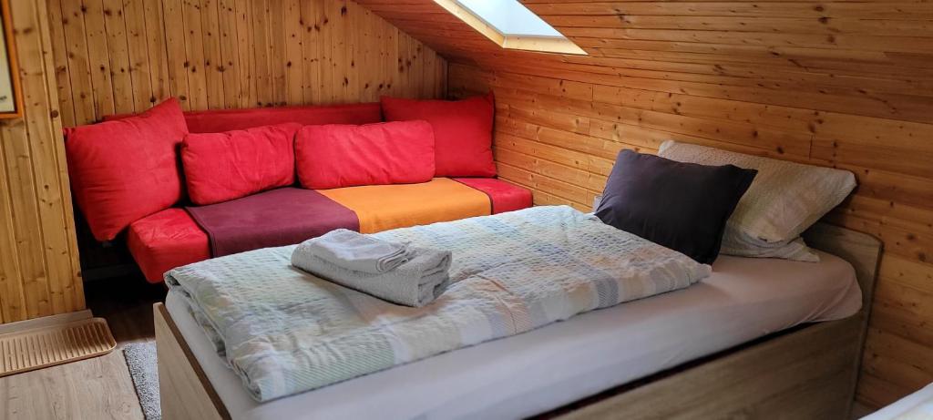 Habitación con cama y sofá en una cabaña en Pension Schlafstuhl, en Aschheim