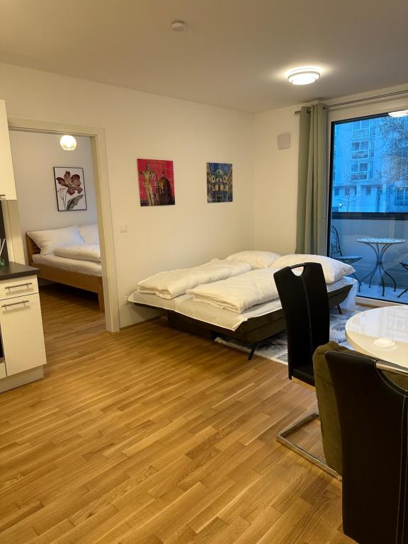 a room with two beds and a table and chairs at Amazing City Center Apartment in Vienna