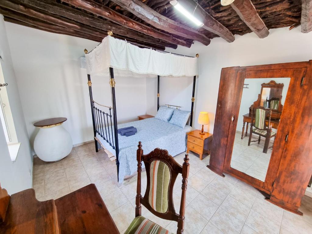 a bedroom with a bed and a mirror at Poseidon's Pool Paradise in Skarinou