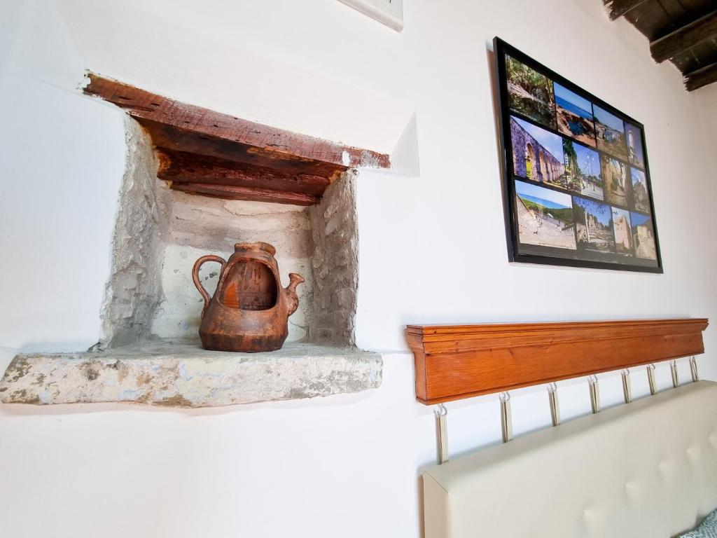 a tea kettle sitting on a fireplace in a room at Poseidon's Pool Paradise in Skarinou
