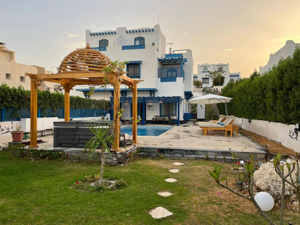 a house with a gazebo and a pool at Amazing 4 Bedrooms Panoramic Sea View Private Villa With Pool, Jacuzzi, Amaros Sahl Hasheesh, Hurghada in Hurghada