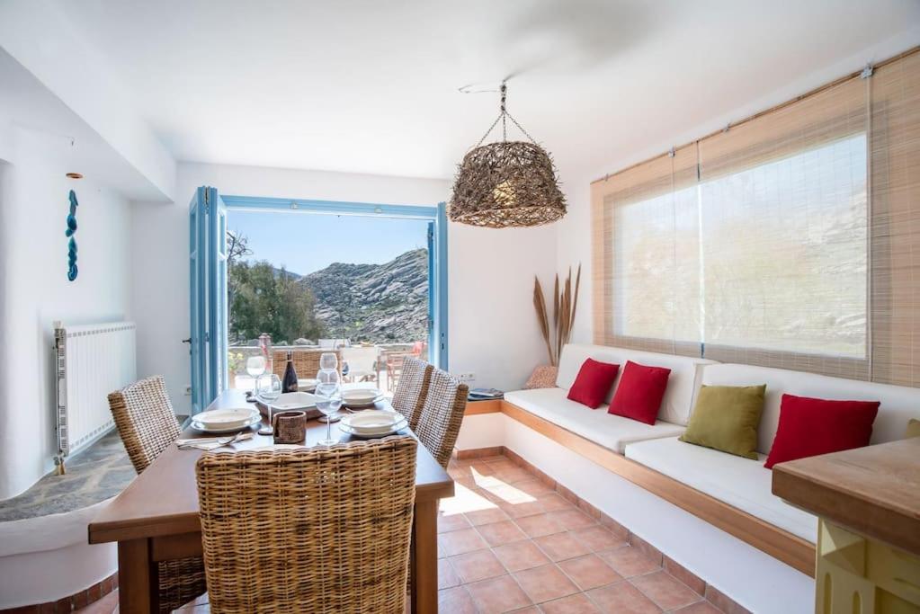 a living room with a table and a couch at Kolimpithres beach house in Naousa