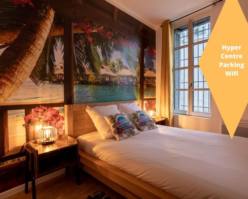 une chambre avec un lit avec un tableau sur le mur dans l'établissement Hawaï wifi Hypercentre arènes, à Nîmes