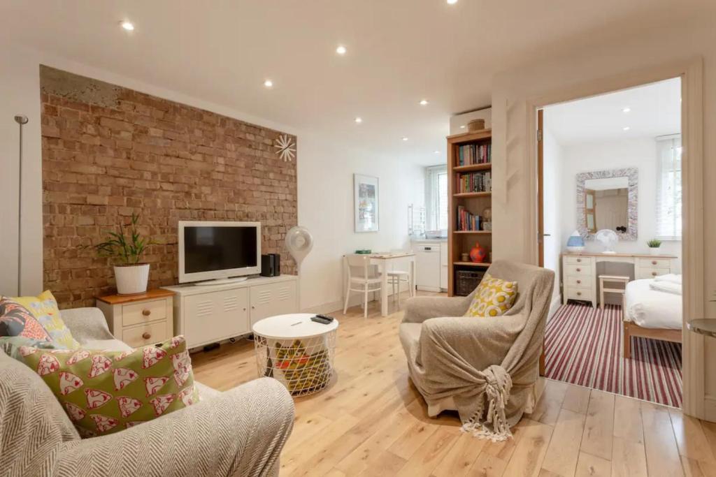 a living room with a brick wall at Inviting & Peaceful 1BD flat in Lambeth in London