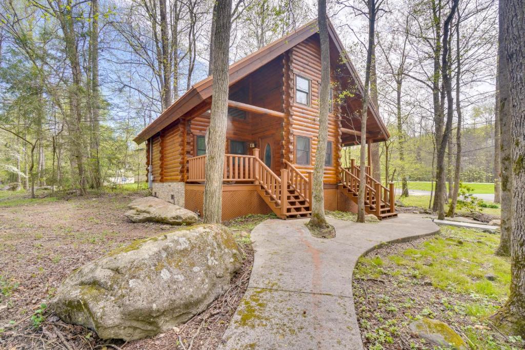 a log cabin in the woods with a path leading to it at Lovely Gatlinburg Cabin with Private Hot Tub! in Gatlinburg