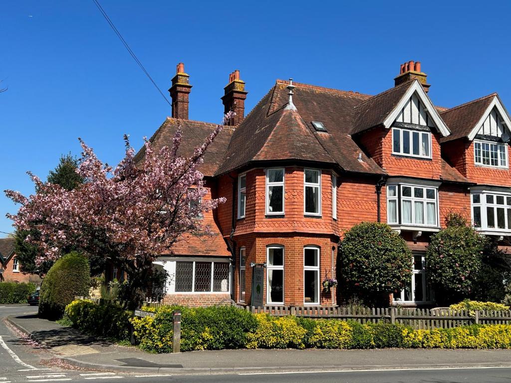 a large red brick house with a black roof at Forest Side Guesthouse in Lyndhurst