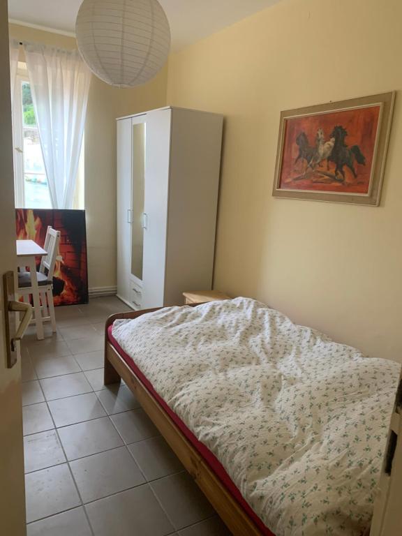 a bedroom with a bed and a cabinet at Burgfreiheit in Heidelberg