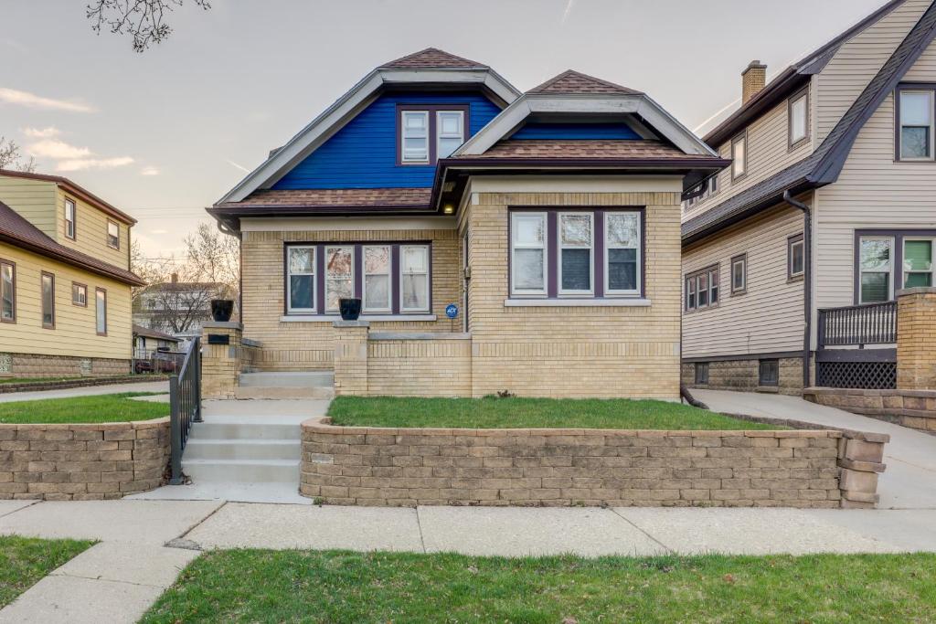 a blue house with a brick wall at Milwaukee Vacation Rental - 2 Mi to Dineen Park! in Milwaukee