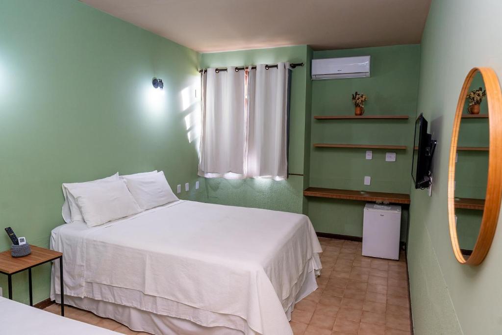 Cama ou camas em um quarto em Casarão Alpina
