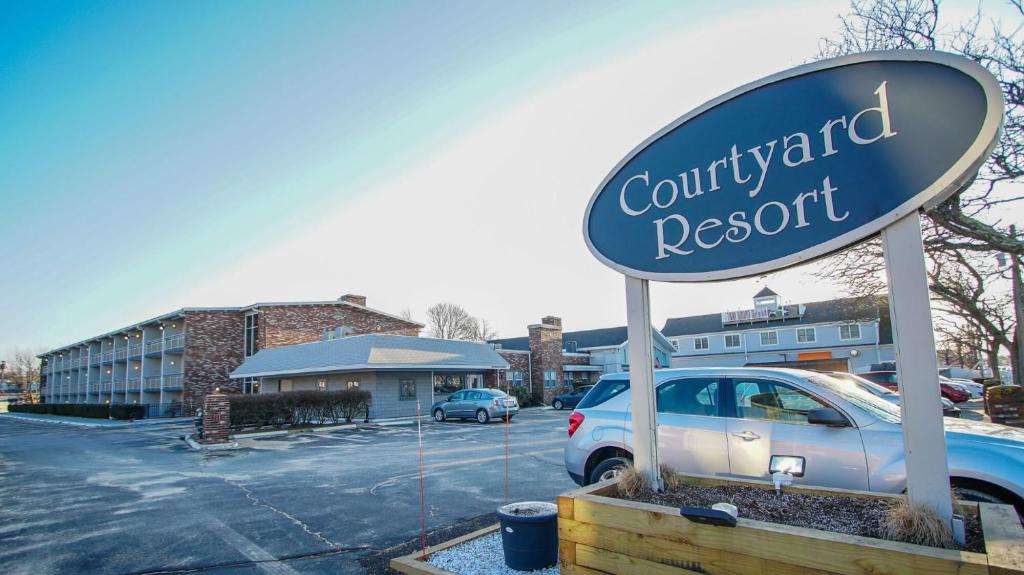 a sign for a court yard resort in a parking lot at Courtyard Resort in Hyannis