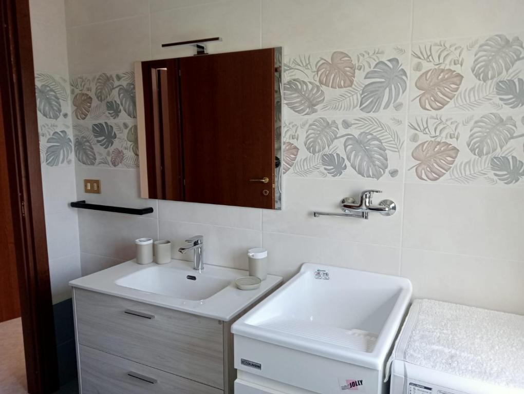 a bathroom with a sink and a mirror at casa LULU due minuti dal mare in Ardore Marina