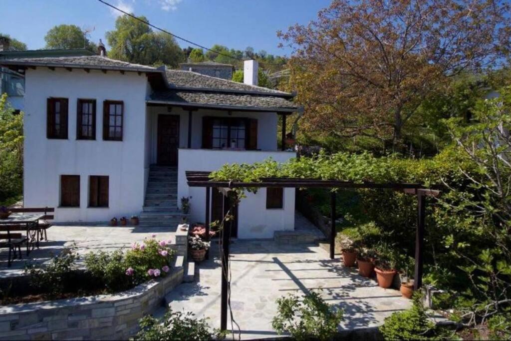 a white house with a patio in front of it at Sea & Mountain Pelion in Mouresi