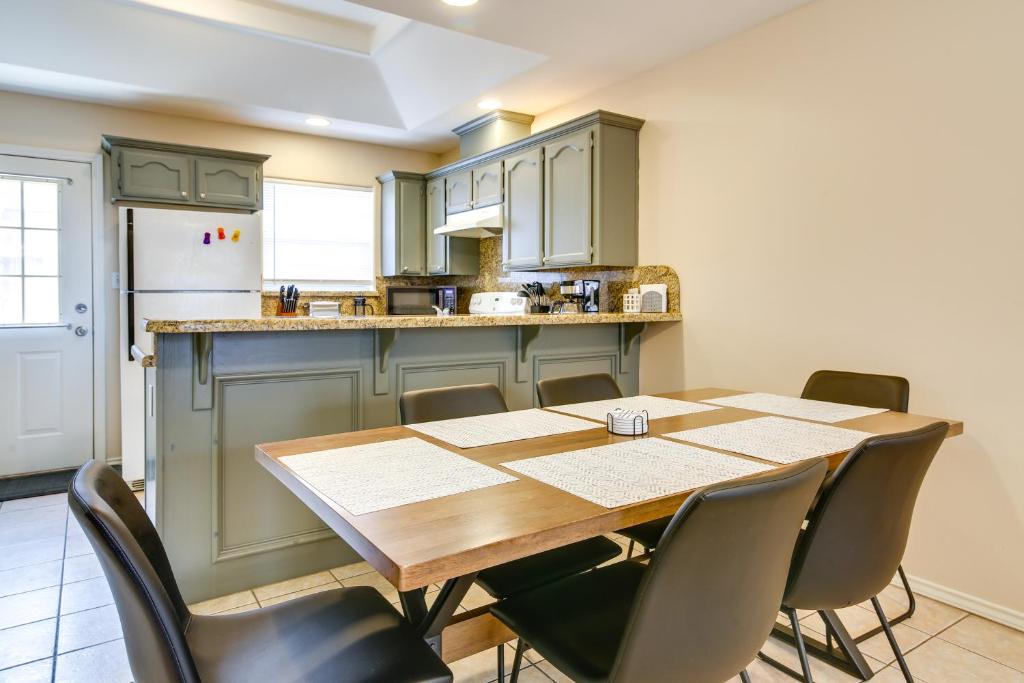 a kitchen with a table and chairs and a refrigerator at Lovely Mission Apartment in Prime Location! in Mission