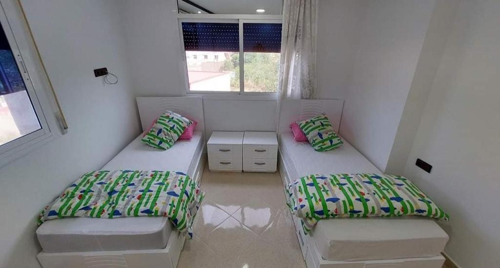 Postel nebo postele na pokoji v ubytování Al Hoceima Ajdir Maroc - Maison 5 chambres 12 personnes
