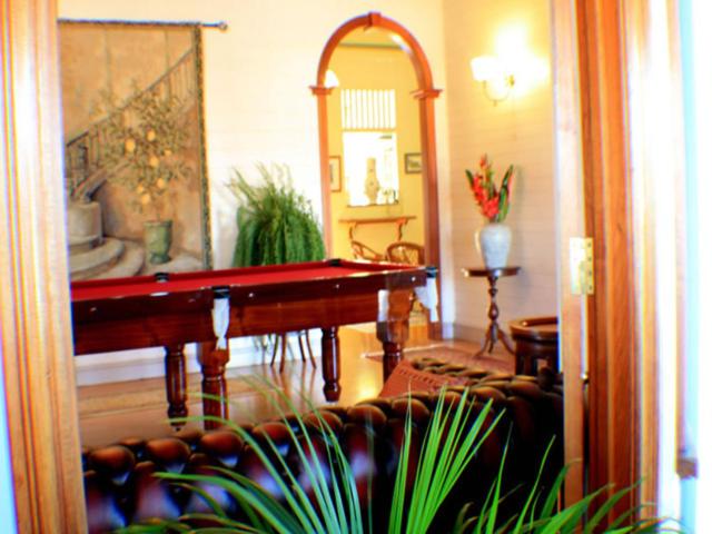 a living room with a pool table and a couch at Classique Bed & Breakfast in Townsville