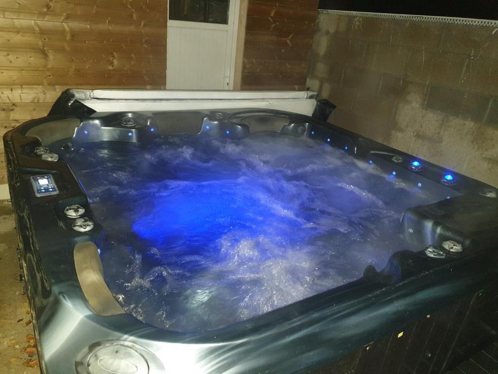 eine Whirlpool-Badewanne mit blauem Wasser in der Unterkunft Gîte Atypique avec jacuzzi in Hillion