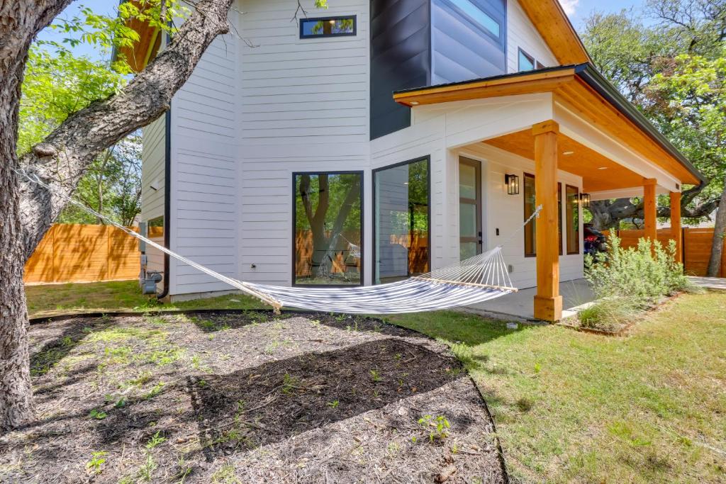 a hammock in front of a house at Chic Austin House with Spacious Backyard and Hammock in Austin