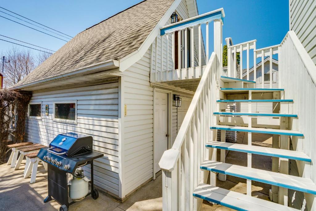 a tiny house with stairs leading up to a garage at Lake Pepin Waterfront Cottage - Steps to Beach! in Lake City