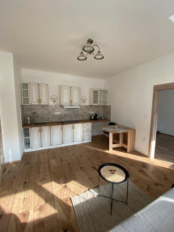 an empty kitchen with a table and chairs in a room at Byt 4+kk mozanet. in Ústí nad Orlicí