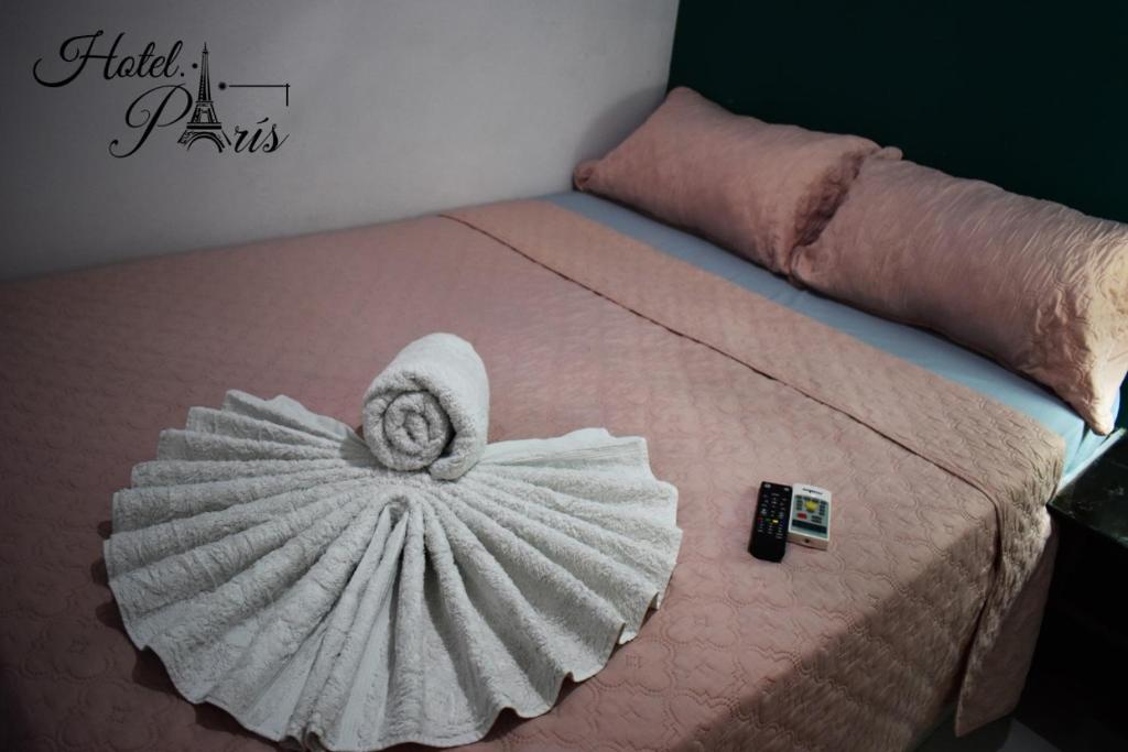 a bed with a towel on top of it at hotel marsella in Sonsonate