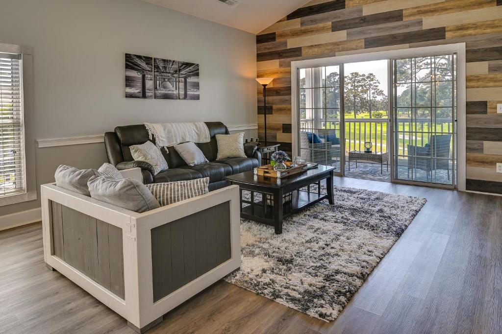 a living room with a couch and a table at Idyllic Myrtle Beach Condo Golf Course On-Site in Myrtle Beach