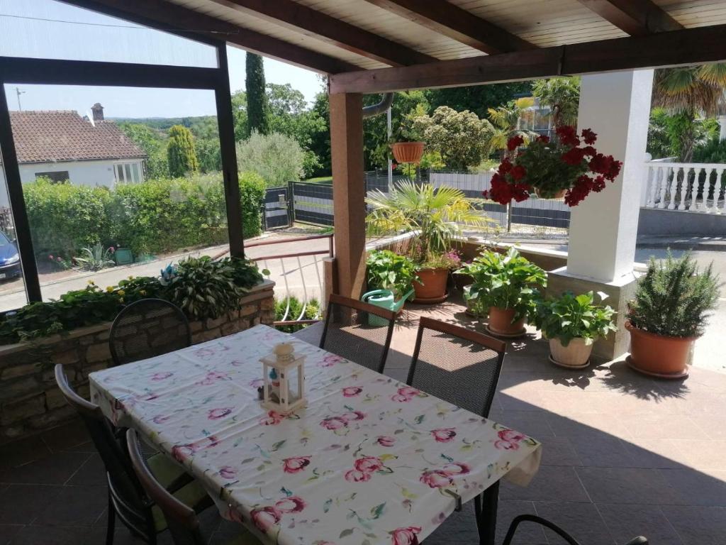 a table and chairs on a patio with potted plants at Apartments with parking space Dajla, Novigrad - 6935 in Novigrad Istria