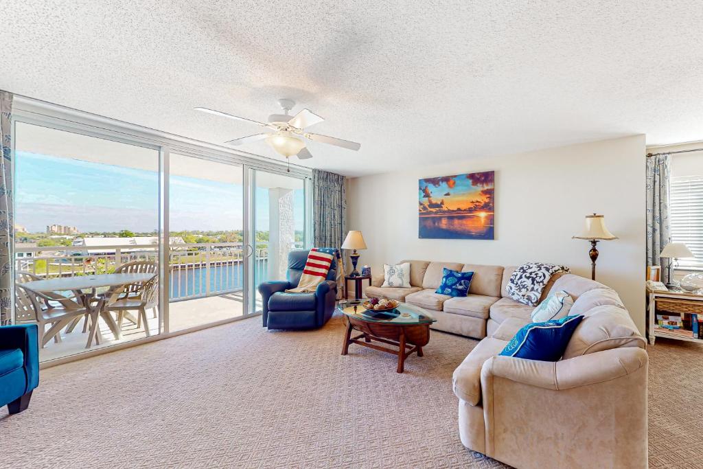 a living room with a couch and chairs and a balcony at Yacht Club Villas 3-505 in Myrtle Beach