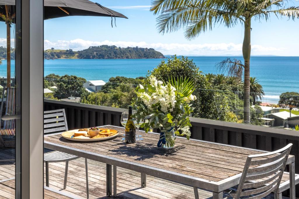 a table on a deck with a view of the ocean at Black Bach in Onetangi