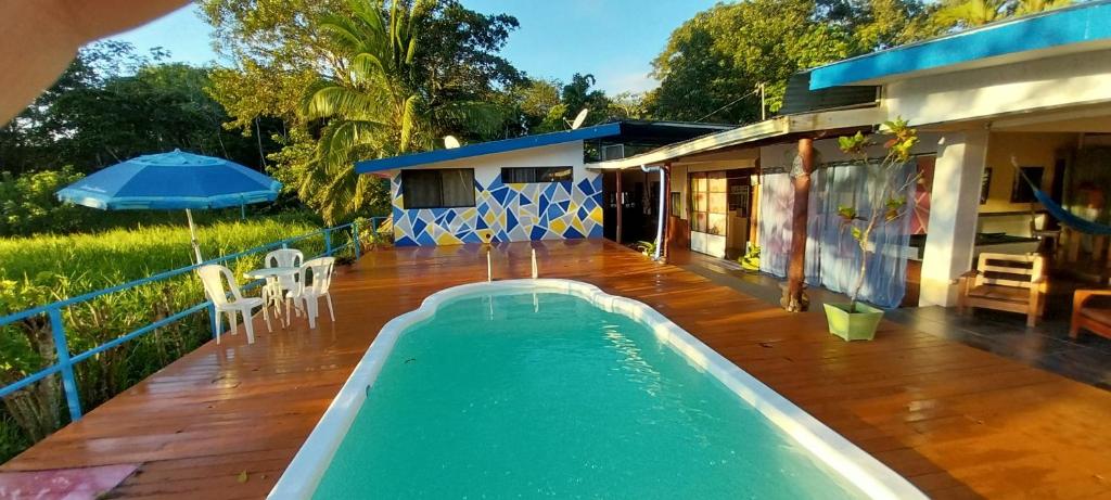 a swimming pool on the deck of a house at Natalias Beach House in Matapalo