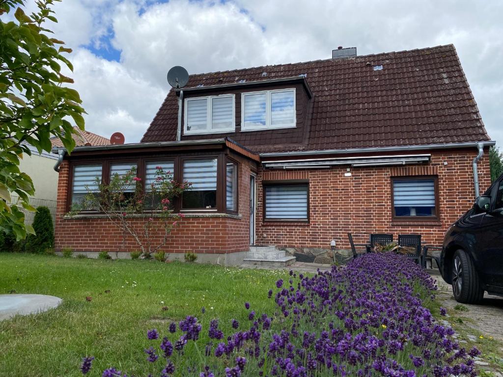 a house with purple flowers in front of it at Strandnähe in Scharbeutz