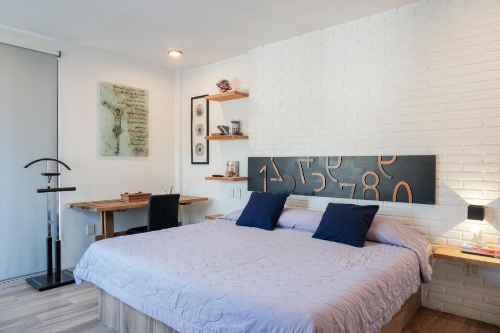 a bedroom with a large bed and a desk at Casa Vista a la Montaña Tlayacapan in Tlayacapan