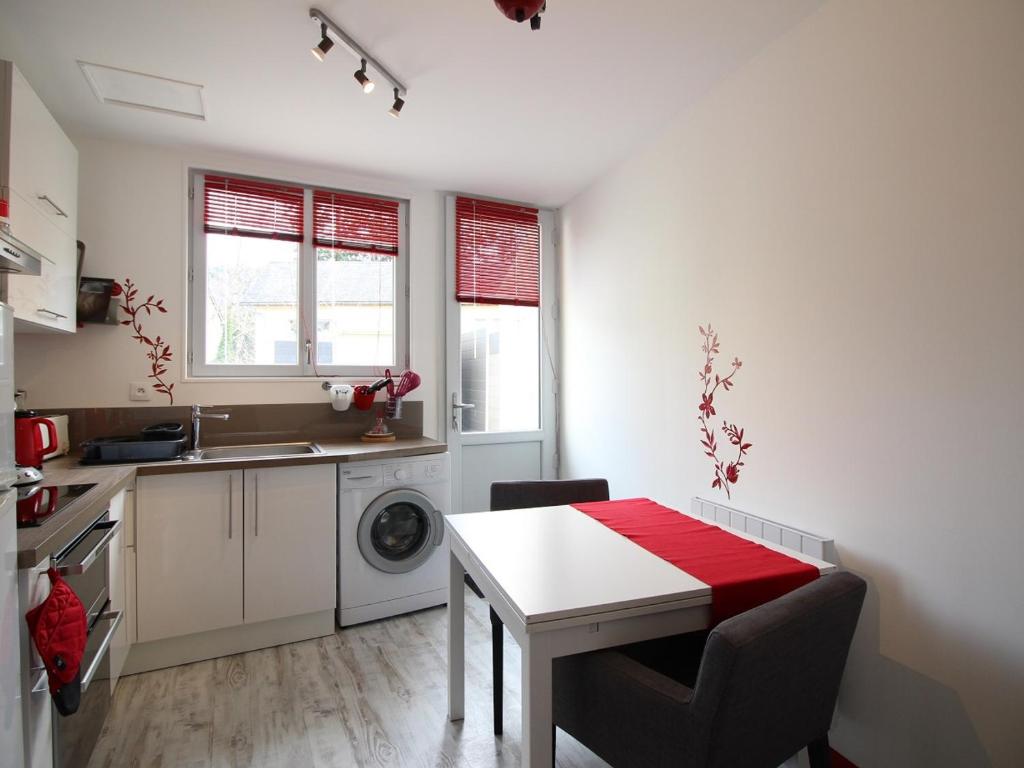 kuchnia ze stołem i pralką w obiekcie La Bourboule : Agréable T2 avec Terrasse, Balcon et Wifi - Proche Centre et Thermes - FR-1-608-245 w mieście Bourboule