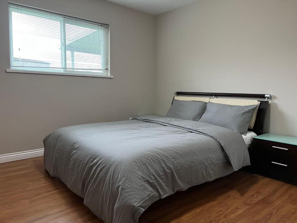 a white bedroom with a large bed and a window at Independent access, one bedroom, one living room, one kitchen and one bathroom in Richmond