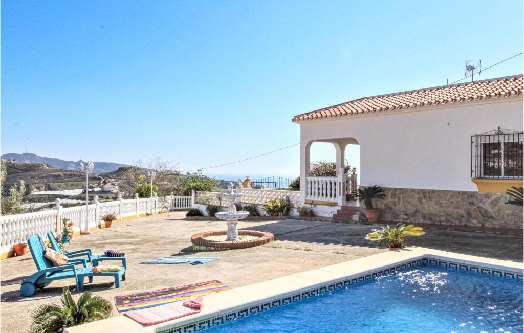 a villa with a swimming pool and a house at Villa Pastor, Torrox, Málaga in Torrox