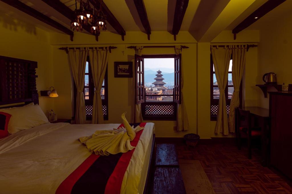 Postel nebo postele na pokoji v ubytování Vajra Boutique Hotel