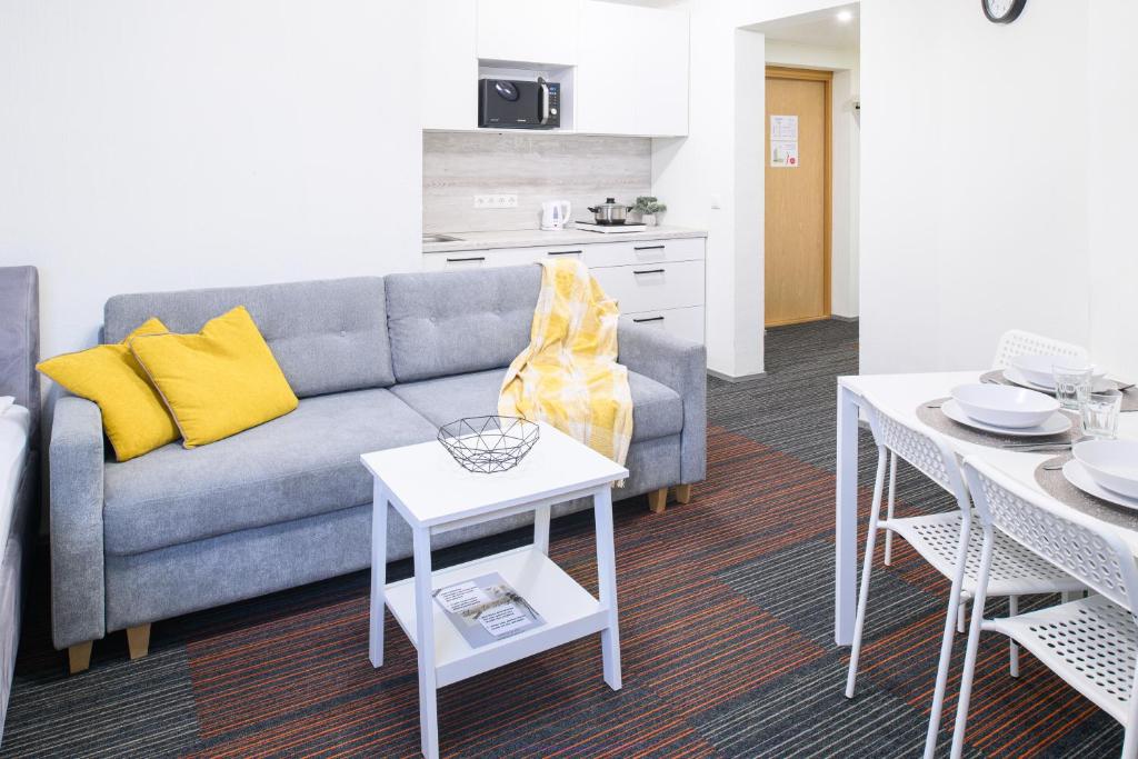 a living room with a couch and a table at Stay to Stay Apartments - võtmeta sissepääs in Tartu