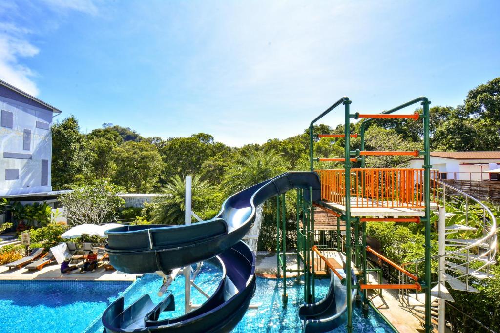 a water slide in a swimming pool with a water park at Aonang Viva Resort - SHA Plus in Ao Nang Beach
