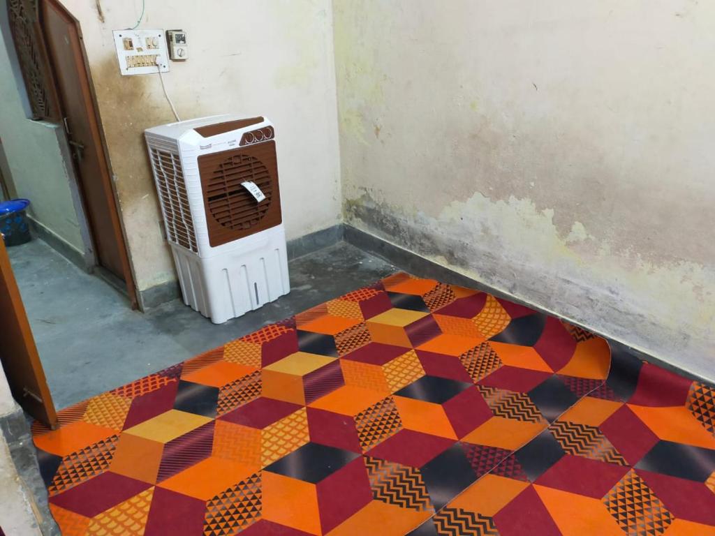 a room with a tiled floor in front of a heater at Prabhu Raj villa HomeStay in Varanasi