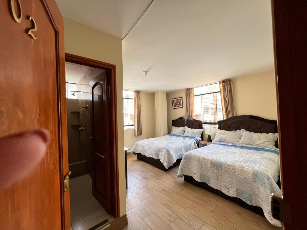 Postel nebo postele na pokoji v ubytování Antara Hostal