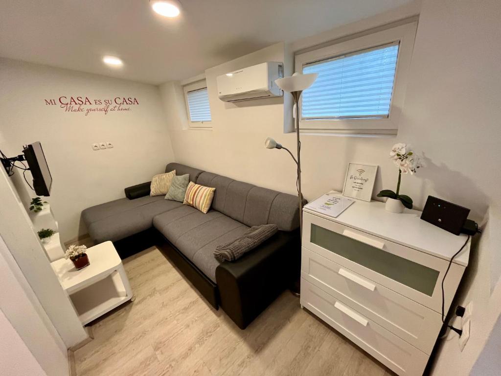 a small living room with a couch and a table at Apartment TiSa, Bled in Bled
