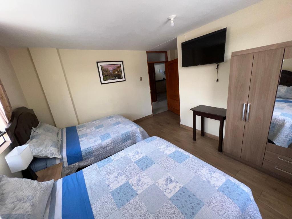 Postel nebo postele na pokoji v ubytování Antara Hostal