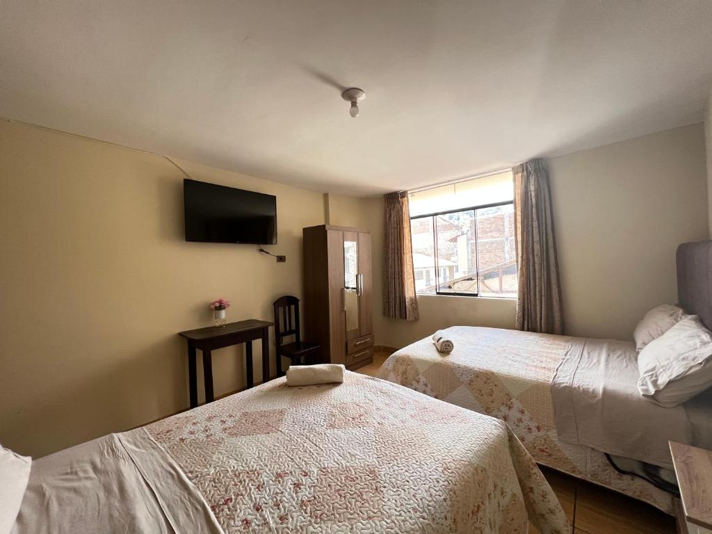 Postel nebo postele na pokoji v ubytování Antara Hostal