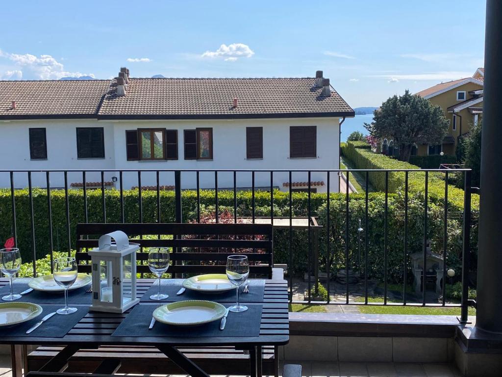 a black table with wine glasses on a balcony at Melograno in Feriolo in Baveno