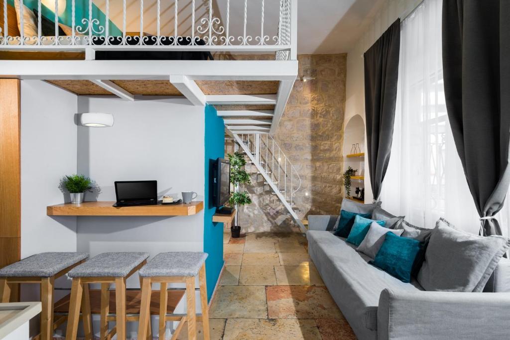 a living room with a couch and a table at Agripas #4 in Jerusalem