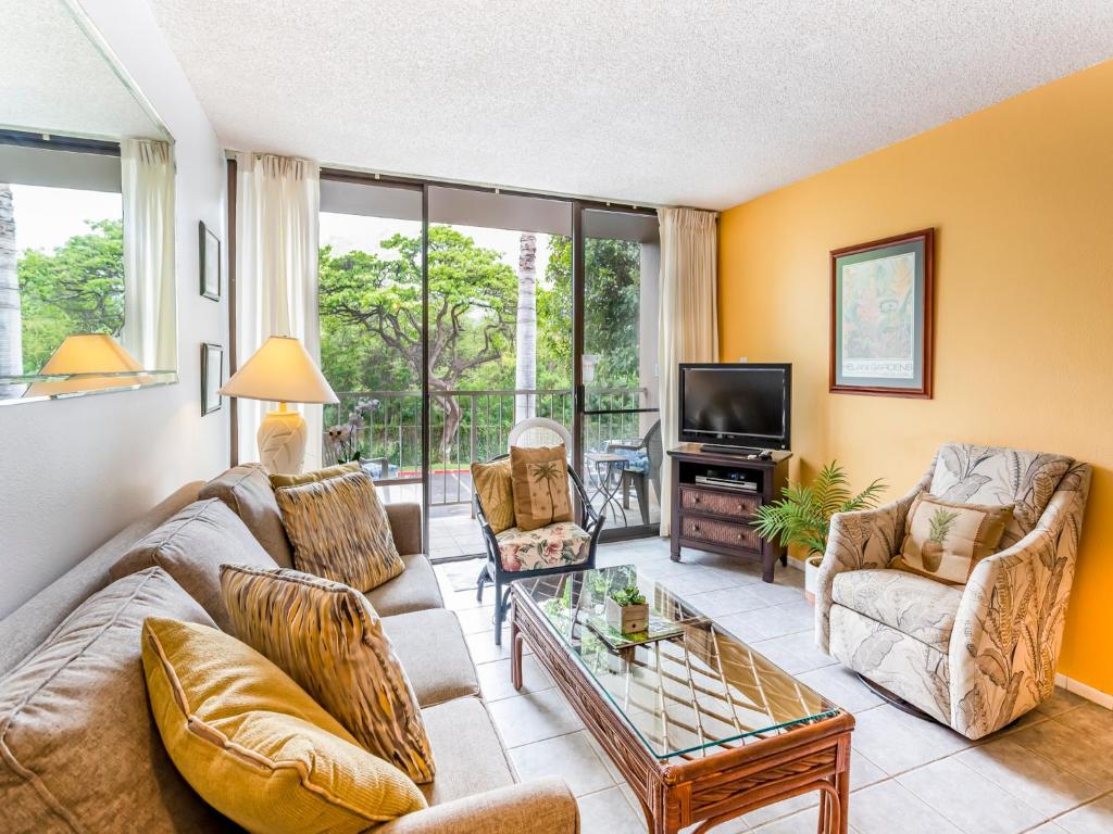 a living room with a couch and chairs and a tv at Pacific Shores A-105 - Ground Floor Family Condo in Kihei