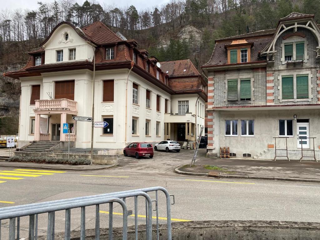 a group of buildings on the side of a street at STUDIOS à louer in Courrendlin